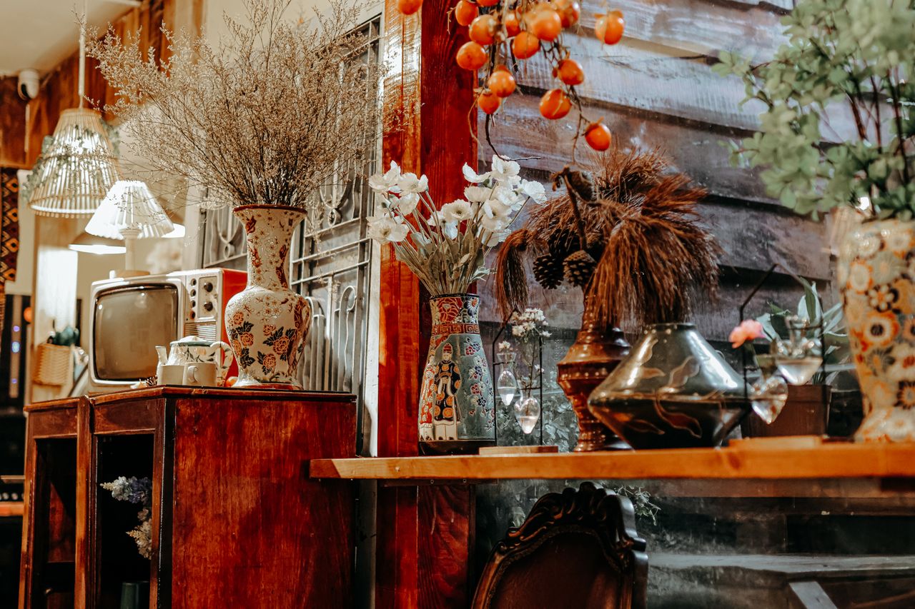 services-01 Cozy rustic interior featuring vintage decor, floral vases, and antique TV.